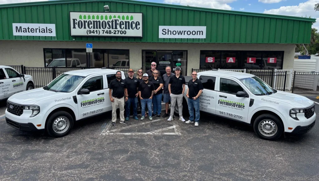 the foremost fencing team standing next to their office